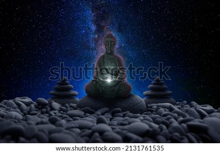 Buddha image between stones and universe background