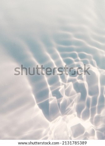 Blur​ abstract​ of​ surface​ blue​ water. Abstract​ of​ surface​ blue​ water​ reflected​ with​ sunlight​ for​ background. Blue​ sea or Blue​ water.​ Water​ splashed​ use​ for​ graphic​ design. Water​