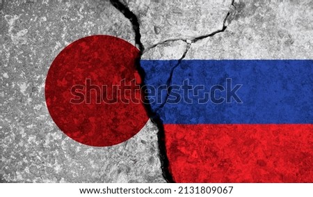 Political relationship between Japan and russia. National flags on cracked concrete background