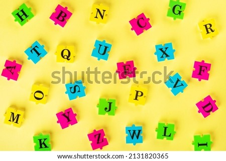 Top view of english alphabet from multi-colored puzzles Simulator for learning English. Educational process. School, lessons, pedagogy. The concept of thinking development, grammar.