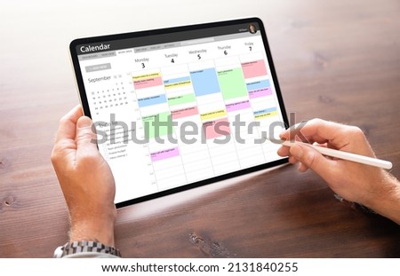 Man using calendar app on tablet computer