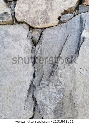 Close up of a brick wall made of natural stone, background