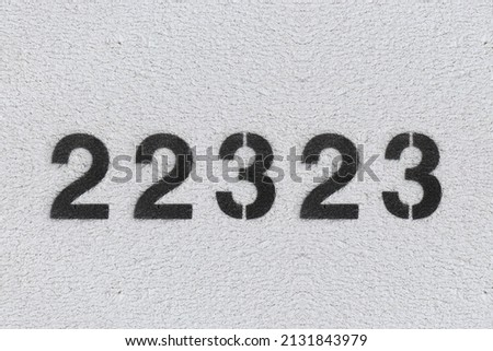 Black Number 22323 on the white wall. Spray paint.two hundred and two thousand three hundred and twenty threetwo hundred and two thousand three hundred and twenty three
