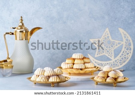   Assorted semolina maamoul or mamoul cookies with dallah and ramadan decor. Traditional arabic Eid al Adha, Eid al Fitr sweets                               Royalty-Free Stock Photo #2131861411