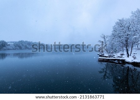 A beautiful photo of snow-covered landscape and a lake