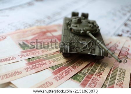 toy tank on the russian banknotes 5000 roubles crisis risk sanctions war conflict russia ukraine wallpaper Royalty-Free Stock Photo #2131863873