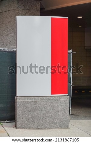 Modern two tone vertical blank sign in front of a building
