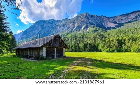 An abandoned hut with a scenic view on mount Dobratsch in the natural park Dobratsch in Villach, Carinthia, Austria. Gailtaler and Villacher Alps. Lush green alpine meadow. Breathing. Remote Location Royalty-Free Stock Photo #2131867961
