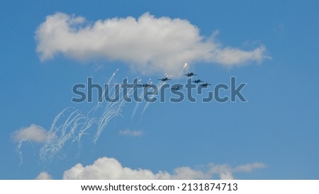multiple aircraft in the sky with chemtrail. conspiracy theory concept. white airliners against blue sky. photo.