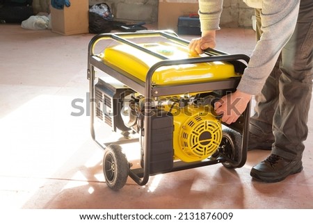 Portable gasoline generator.The use of an autonomous energy source. An additional source of energy. Royalty-Free Stock Photo #2131876009
