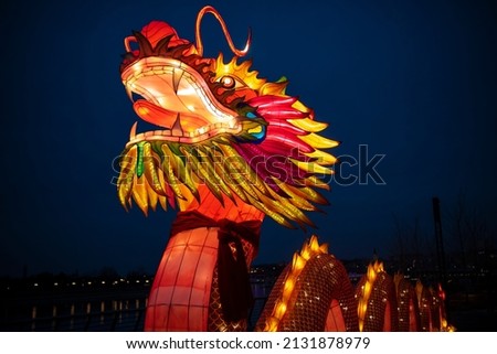 Closeup of a huge colorful bright glowing chinese dragon Lun during the Chinese New Year celebration. Lantern festival during night.