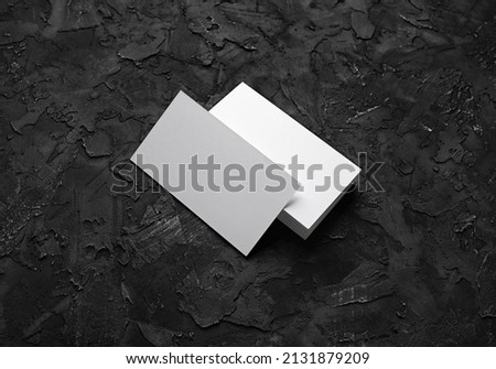 Blank business cards on black stone background. Mockup for branding identity. Template for graphic designers portfolios.