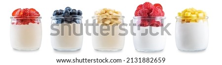 Set of Greek yogurt raspberry, mango, strawberry, blueberry, banana parfait in jars on a white isolated background. toning. selective focus Royalty-Free Stock Photo #2131882659