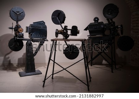Photo of old vintage movie projectors in cinema library.