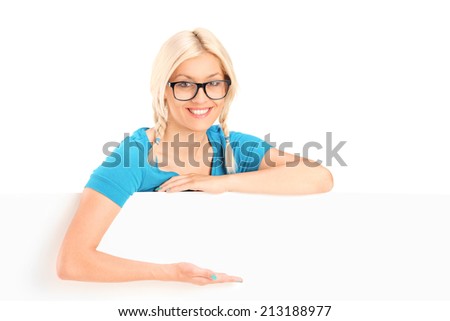 Blond woman gesturing with hand behind a panel isolated on white background