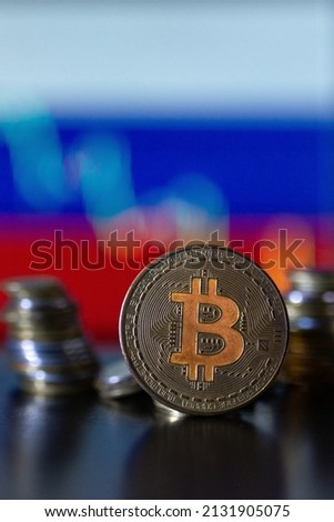 Bitcoin coin on the background of the Russian flag with a decline chart.
