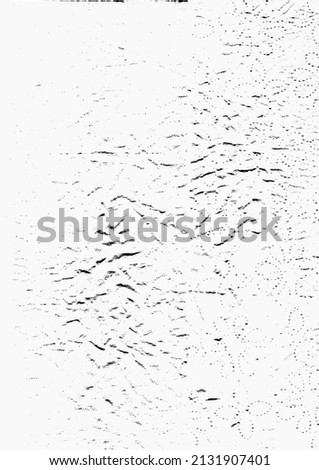 Picture of a highly textured background. Various designs can be found in the highly contrasted image. Random spots and textures are detailed in the distressed black and white.