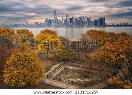 A mesmerizing view of Manhattan from Ellis Island under the cloudy sky - wallpaper