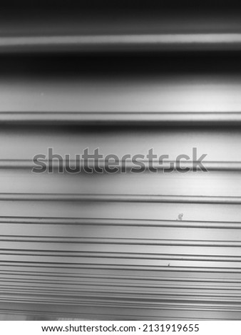 solid metal objects arranged horizontally in gray with black shadows.
