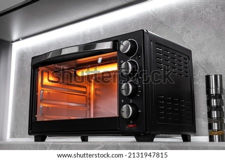 Electric mini oven for homemade cooking Royalty-Free Stock Photo #2131947815