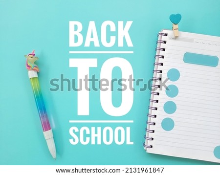 School concept with word "Back to school" on blue background.