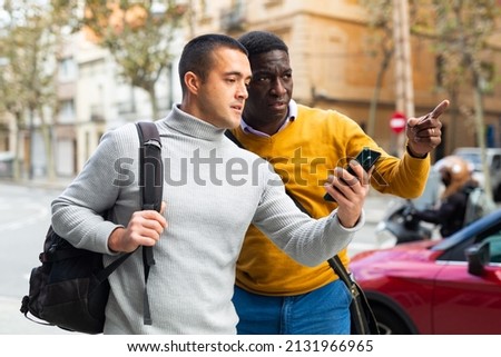 European man with smartphone having conversation with African-american man about directions. Royalty-Free Stock Photo #2131966965