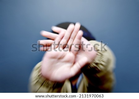 a boy covers his face Royalty-Free Stock Photo #2131970063