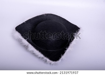 black pirate hat with white feathers on a white background