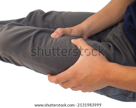 Thigh pain or muscle cramp in asian man with on white background using for health care concept. closeup photo, blurred.