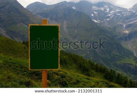 Green plate for the inscription in the mountains. Pointer