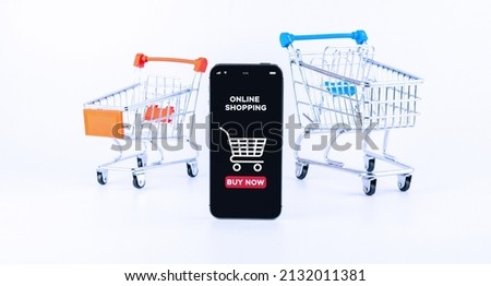 Online shopping. Digital smartphone with online shop application, shopping trolley on white background. Internet purchase, online shop concept. Website retail business