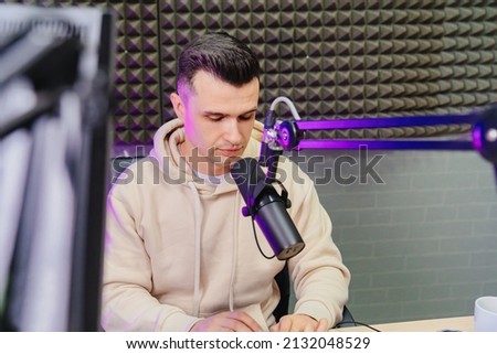 radio host financial analyst preparing for the broadcast, reading news currency exchange rate and trading on the stock exchange on a radio station