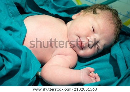 a newly born newborn lies in a diaper with an umbilical cord Royalty-Free Stock Photo #2132051563