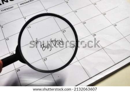 Big day wording with magnifying glass on a calendar 