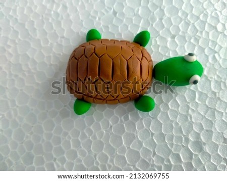 plasticine turtle isolated on white background.handmade tortoise made with modeling clay.turtle sculpture.copy space for text 