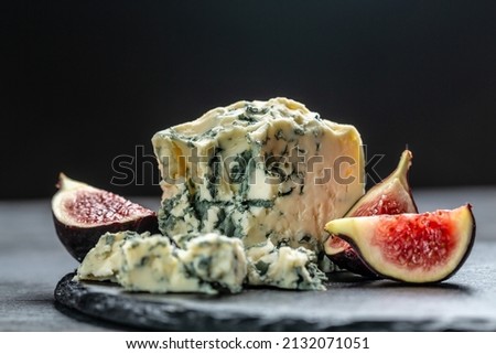 blue cheese and sweet fruit figs. blue cheese gorgonzola picante with blue mold from north of Italy. Food recipe background. Close up. Royalty-Free Stock Photo #2132071051