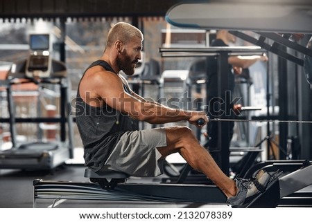Training legs in the simulator, the athlete works with his legs on the simulator, working out the muscles on the legs Royalty-Free Stock Photo #2132078389