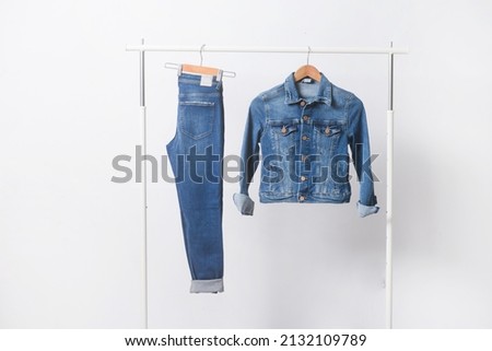 blue jeans and jeans jacket closeup  on hanger Royalty-Free Stock Photo #2132109789