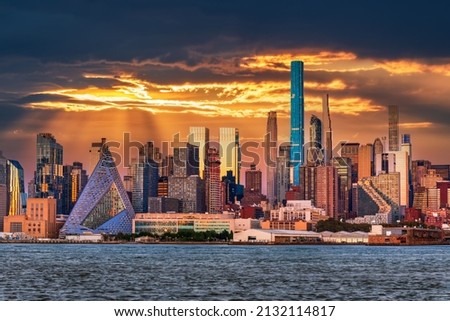 New York, United States - Manhattan colored sunset with skycrapers and Hudson River.