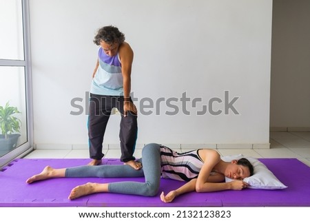 Thai Barefoot Massage technique for the legs (thigh). Hands-free massage. Male massage therapist, female client. Royalty-Free Stock Photo #2132123823