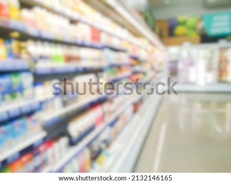 Blurred bokeh beverage cooler products on the shelves of supermarket malls or shopping centers for text.