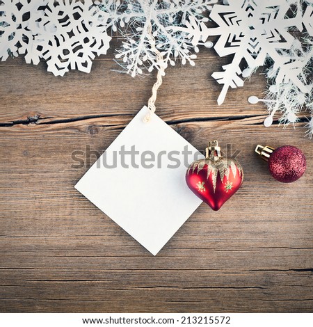Christmas tree decoration and snowflakes on wooden background
