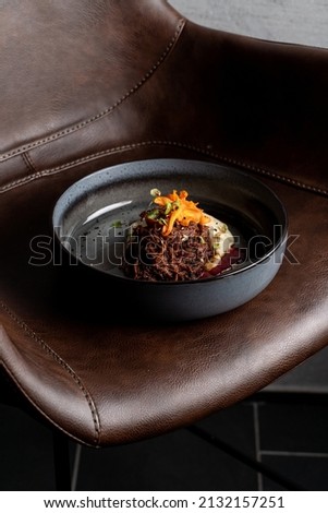 Expensive meal placed on deep brown leather armchair, modern cuisine restaurant photo