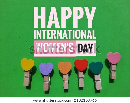 Signage concept with word "Happy International Women's Day" on green background.