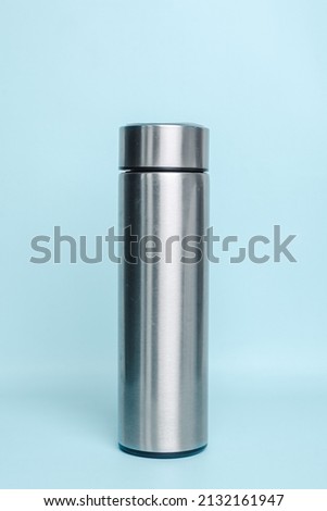 Stainless steel thermos for mock up isolated on a pastel blue background Royalty-Free Stock Photo #2132161947