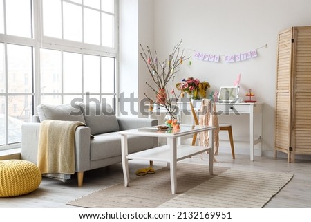 Stylish interior of living room decorated for Easter celebration Royalty-Free Stock Photo #2132169951