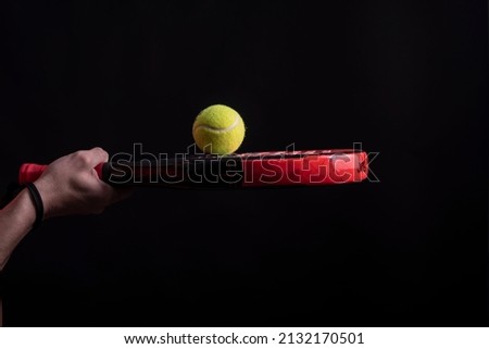 A paddle tennis ball on racket in studio shot Royalty-Free Stock Photo #2132170501