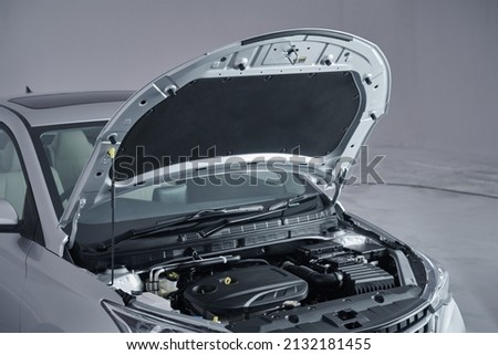A Modern new car close-up of the engine, front top view, show all parts and open hood.  Royalty-Free Stock Photo #2132181455