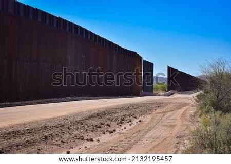 Construction of the border wall along the international boundary between Mexico and the United States. Photographed in Organ Pipe Cactus National Monument, Arizona, USA. Royalty-Free Stock Photo #2132195457