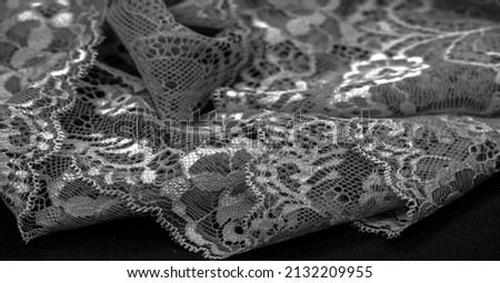 Black lace. Vintage floral background. Lace is an openwork fabric obtained by crossing the threads that form motives connected by the base Royalty-Free Stock Photo #2132209955